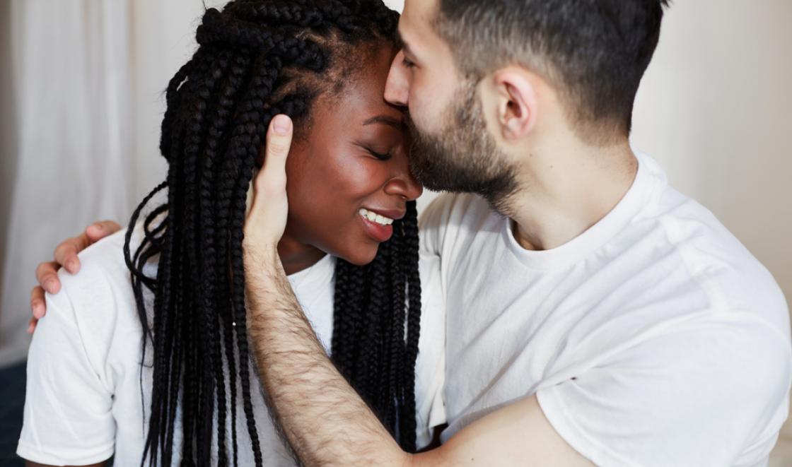 Black woman with white man hugging